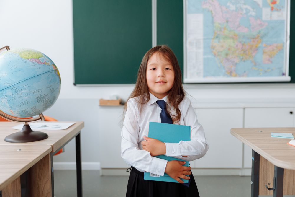 A girl in school uniform holding a book