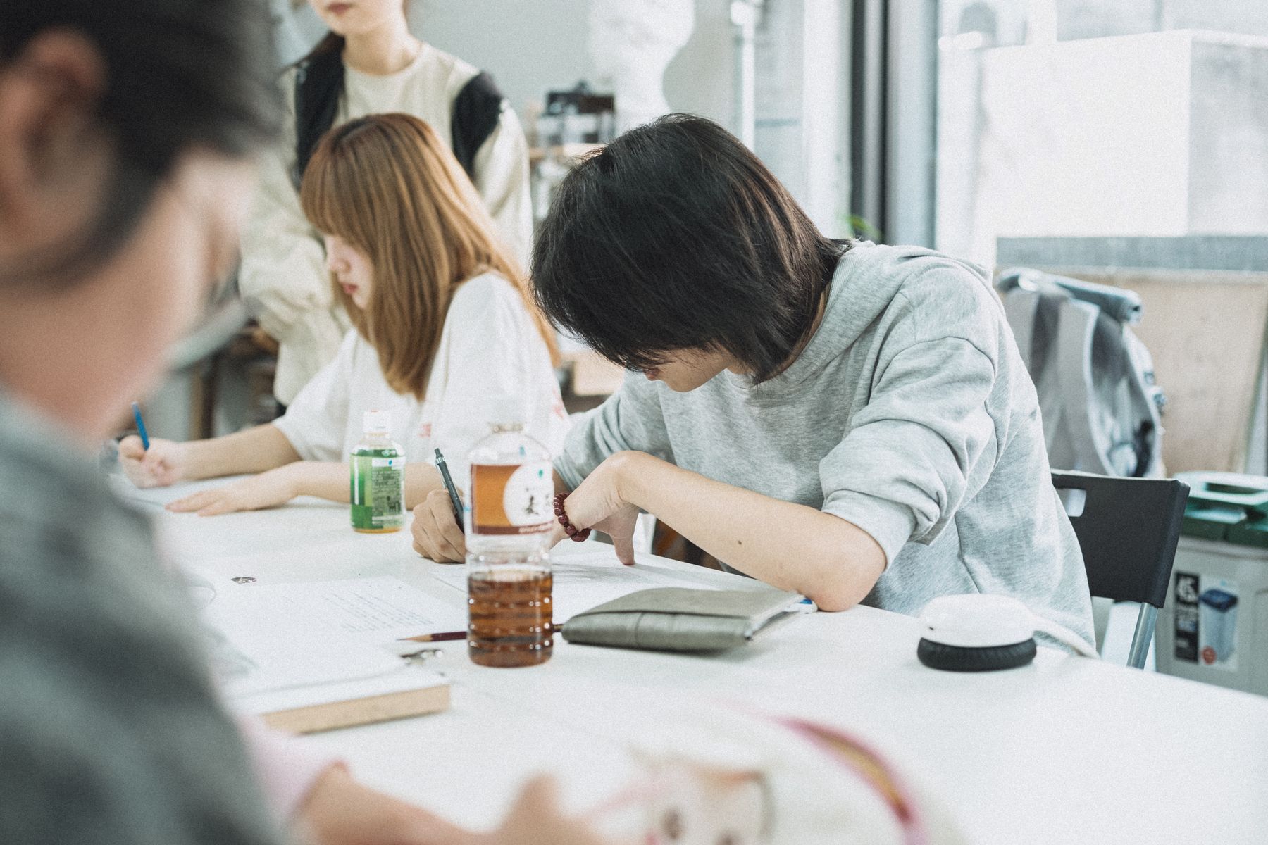 Students studying together at desks in a classroom