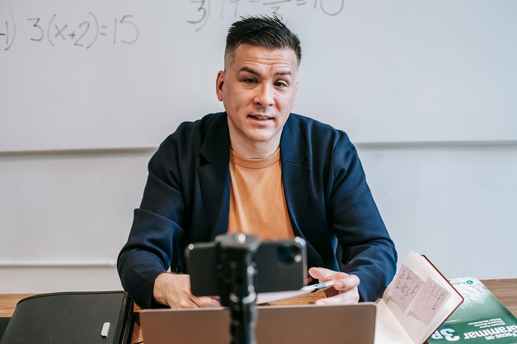 A teacher giving an online class in front of a camera
